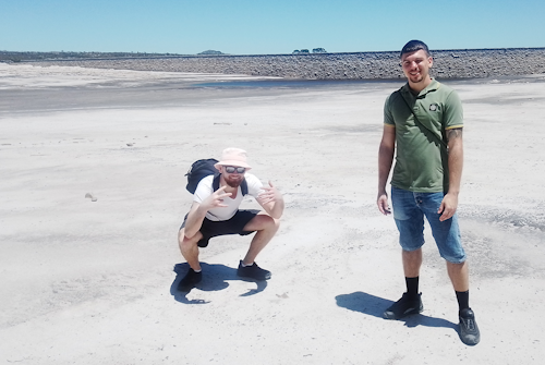 Two visitors from the US, enjoy the vast expanse of beach, while the dam water level is very low.